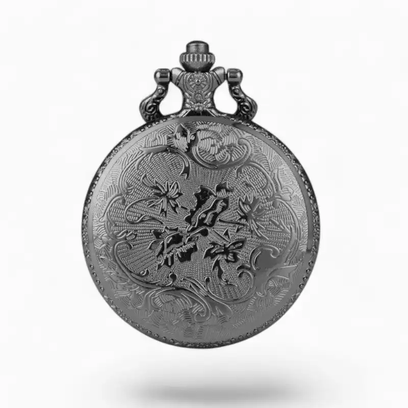 Montre à gousset vintage en métal argenté avec motifs floraux gravés et boussole intégrée.